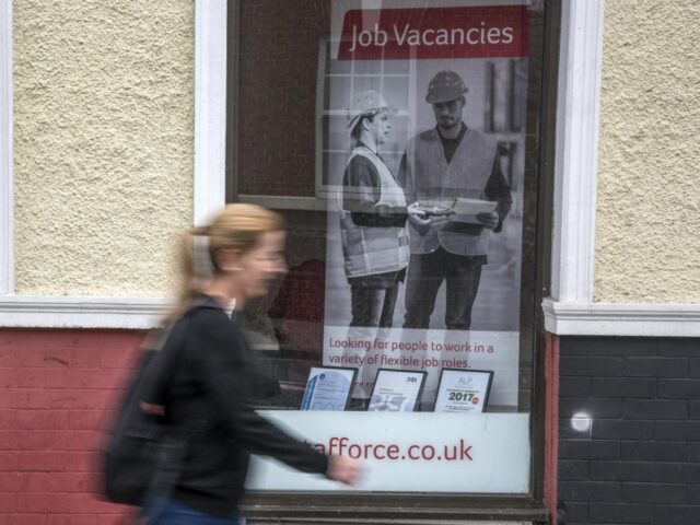 Woman walking past job advert