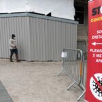 Photo of man walking in mask