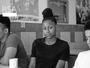 a young woman looks at camera - image from front cover of RSA report