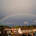 rainbow over houses