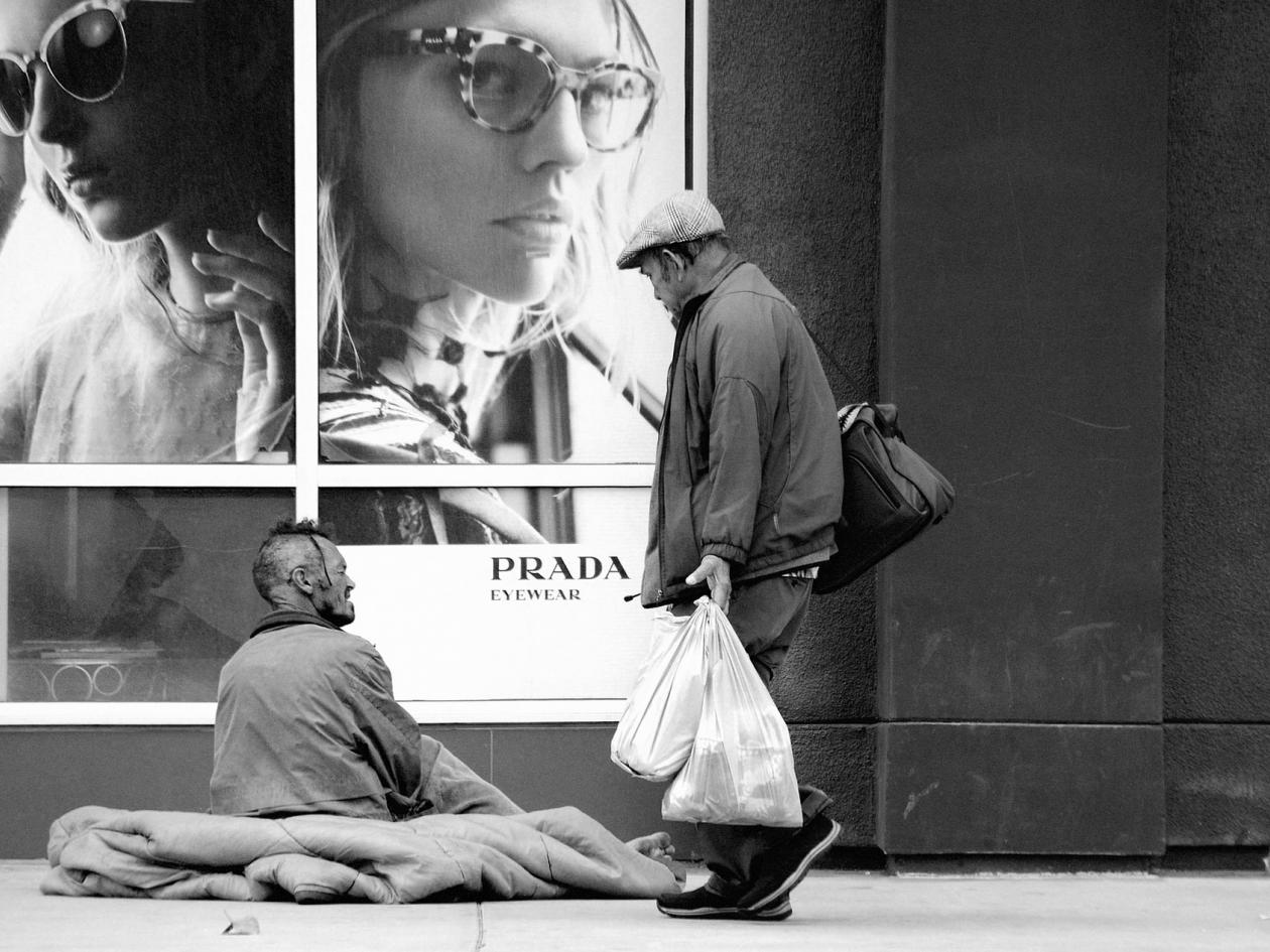 homeless people outside a Prada shop