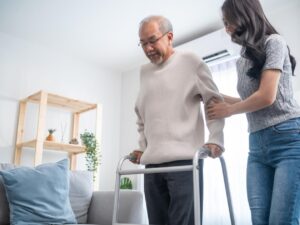 Asian woman supporting older relative