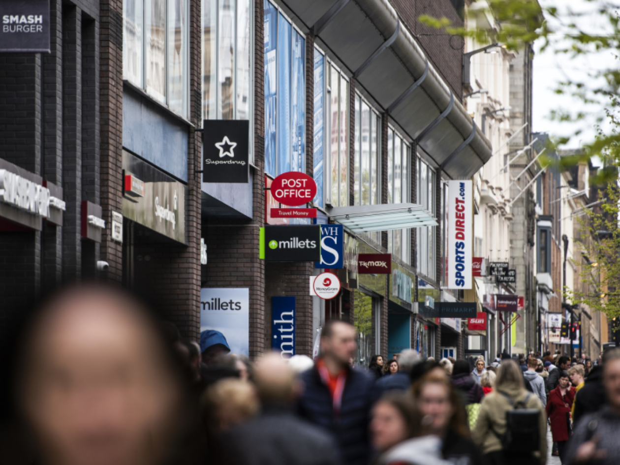 a crowd of people in a shopping area
