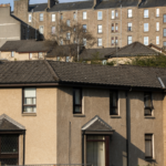 streets of houses of different kinds against a blue sky
