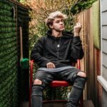 Young man in parents' back garden