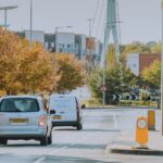 A white car braking behind a white van