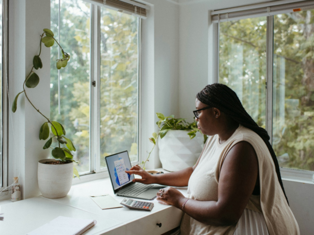 Photo of woman working on a laptop at home