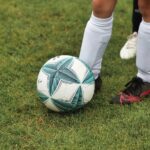 Image by Alexander Fox PlaNet Fox from Pixabay – close-up of a child/teenager’s feet and a football