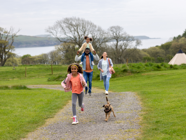 Photo of family walking their dog in the countryside